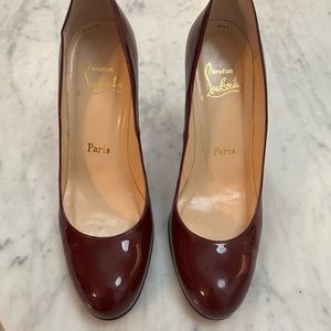 Christian Louboutin patent leather dark red heels. Size is 37.5
